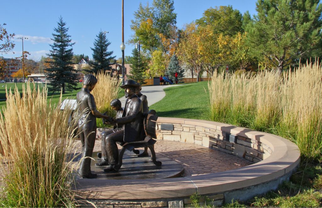 Edward A. Whitney and children statue at Whitney Commons Park