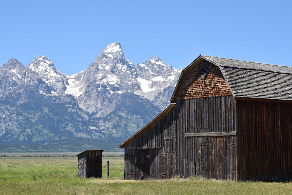 Brown Wooden Shed Near Mountain