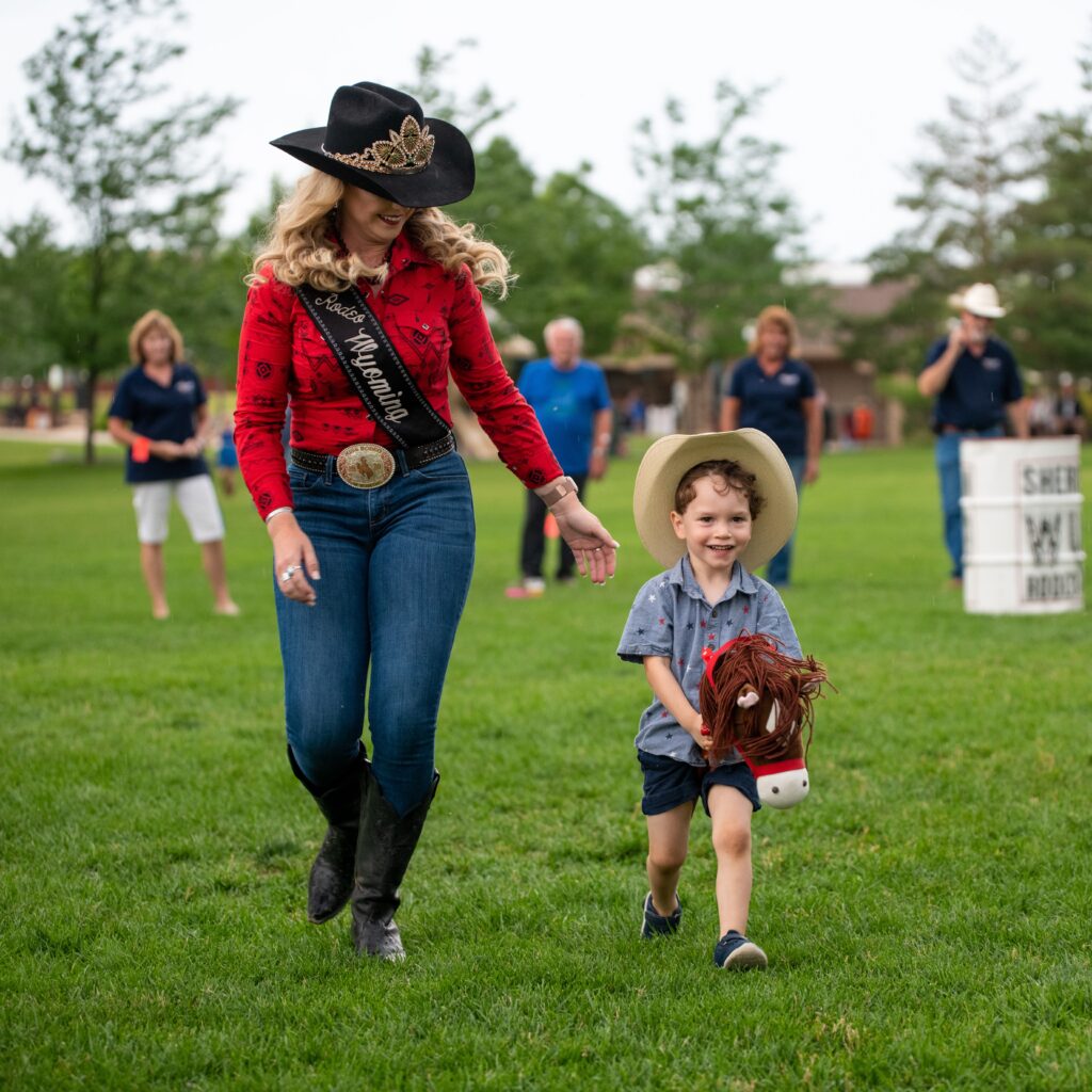 Boot Kick Off Photo of Boy on Stick Horse and Rodeo Princess.